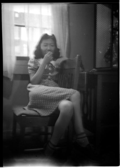 Blurry image of young woman in chair