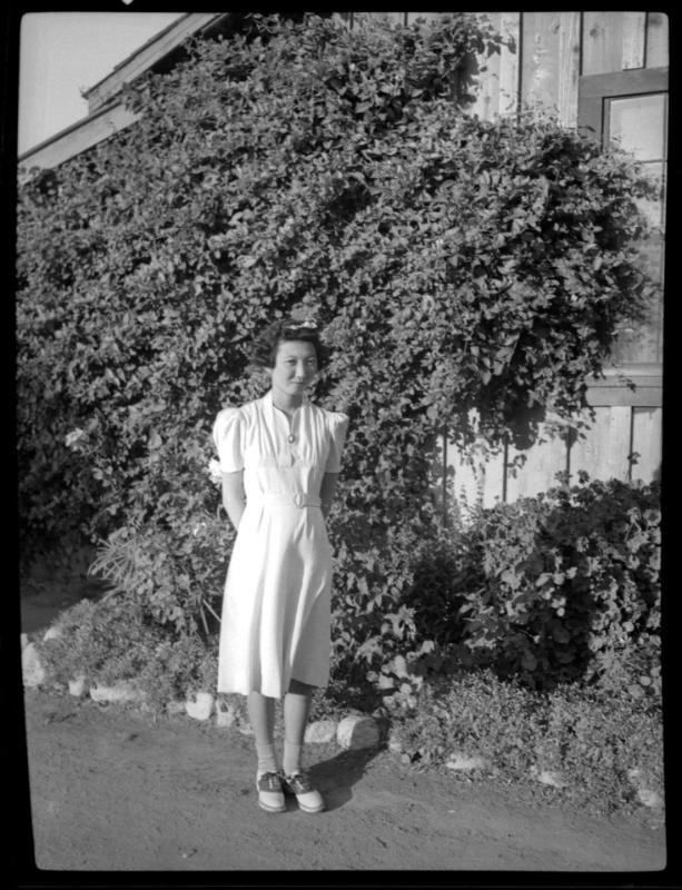 Young woman in front of ivy-covered building