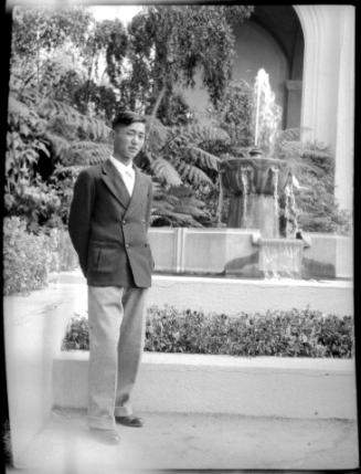 Young man in a courtyard with fountain