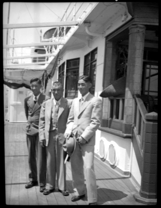 Three men on a ship deck