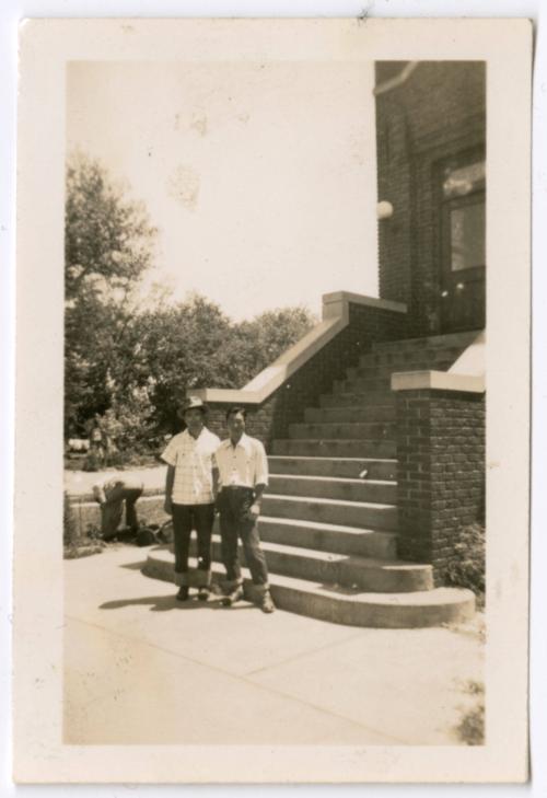 Two men in front of building