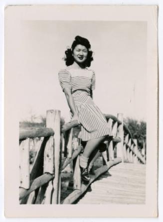 Woman on footbridge railing