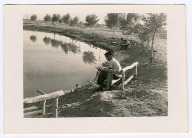 People reading near a canal