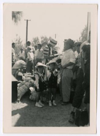 Two children in a crowd