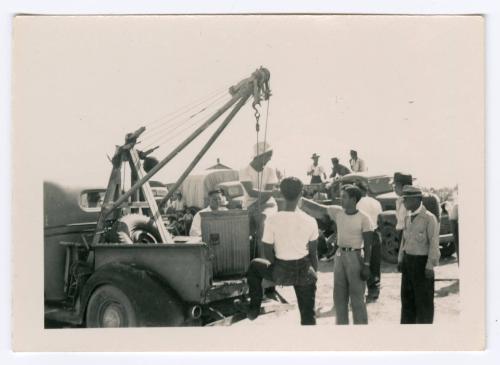 Group around crane in truck bed