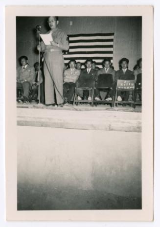 White man in uniform giving speech