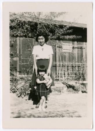 Woman with girl and stuffed dog toy