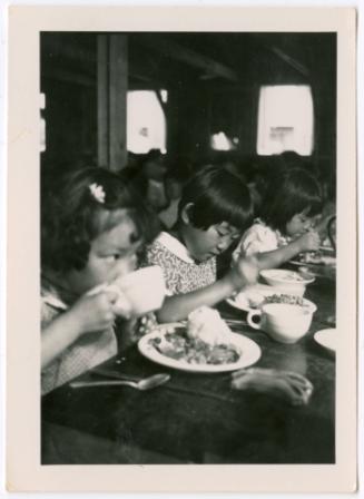 Three children eating