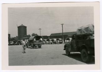 People loading into the beds of trucks