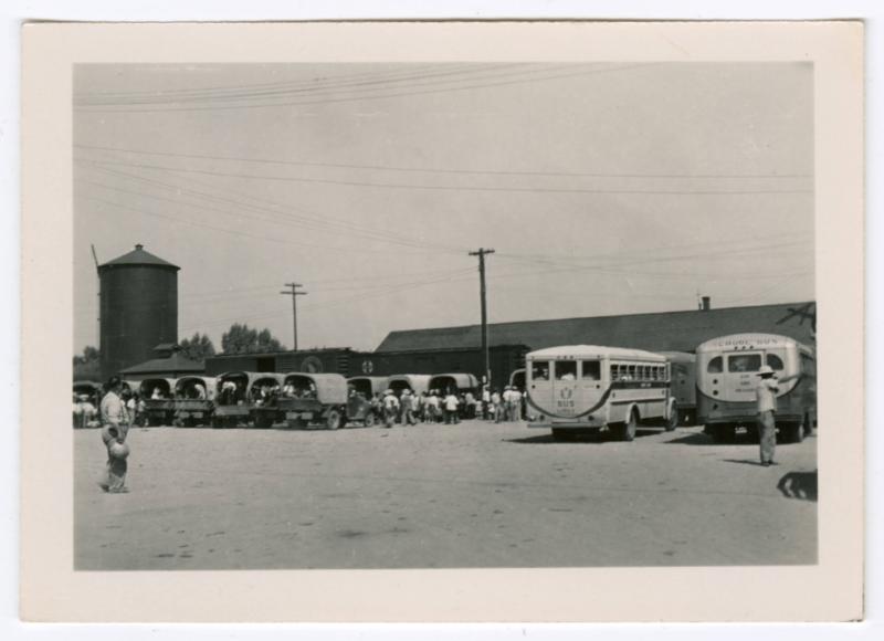 People loading into trucks and buses