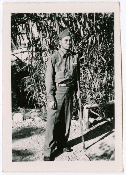 Unidentified military man standing in front of corn