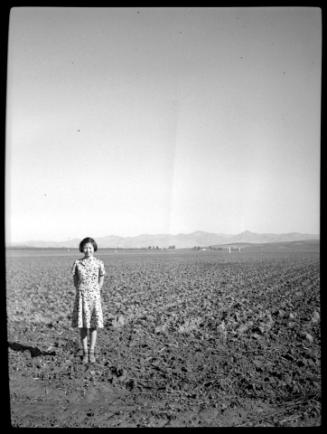 Young woman in empty field