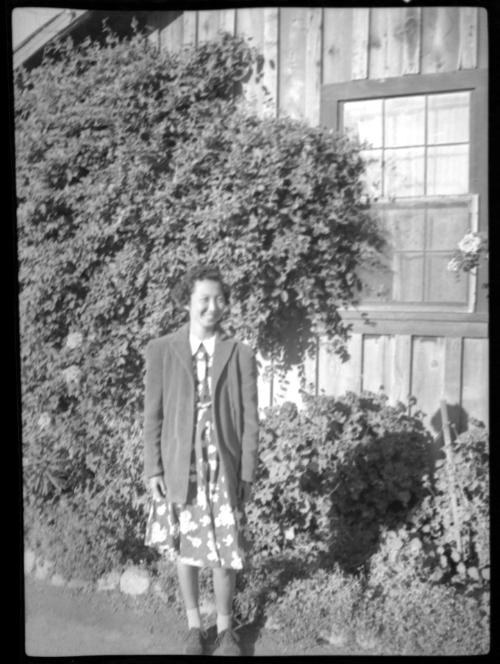 Woman in front of ivy-covered building