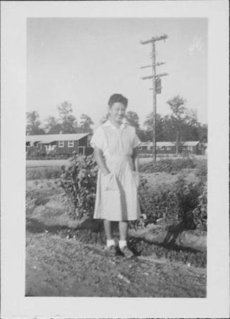[Candy striper standing outside, full-length portrait, Rohwer, Arkansas, October 16, 1944]