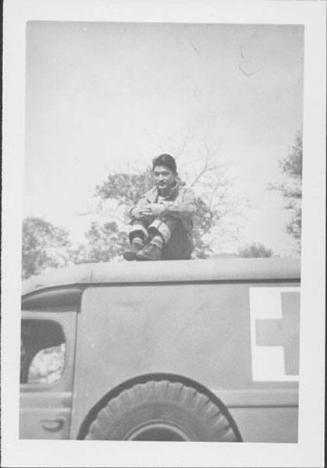 [Man sitting on roof of Red Cross vehicle, Rohwer, Arkansas, November 2, 1944]