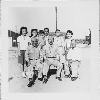 Two United States Army soldiers with seven people in front of automobile, Rohwer, Arkansas, August 20, 1944]