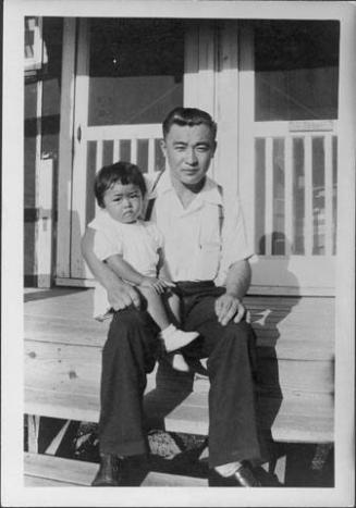 [Man and toddler sitting on porch steps, Rohwer, Arkansas]