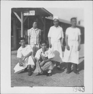 [Woman and four men in aprons, Rohwer, Arkansas, 1943]