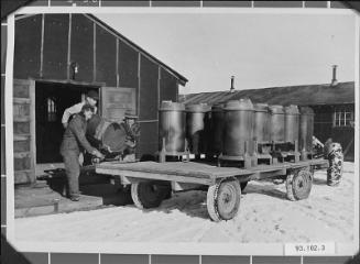 [After the end of World War II, internees brought out coal stoves from camp, ca.1945]