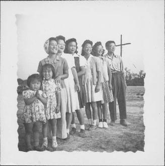[Group portrait of adults and children standing in a line, Rohwer, Arkansas, September 26, 1943]