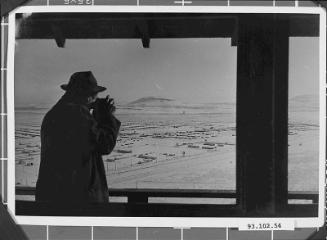 [Robert Ross photographing Tule Lake concentration camp from watchtower, Newell, California, ca. 1943]