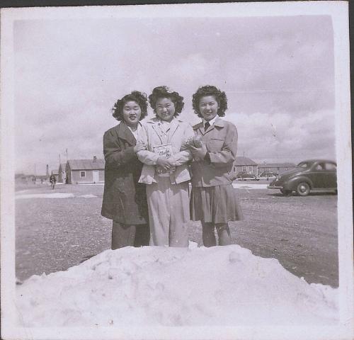 [Three girls standing in snow, Heart Mountain, Wyoming, 1943]