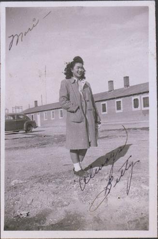 [Betty in overcoat in front of barracks and car, Heart Mountain, Wyoming, Winter 1944-1945]