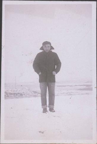 [Portrait of man in black coat standing in snow, Heart Mountain, Wyoming, Winter 1944-1945]