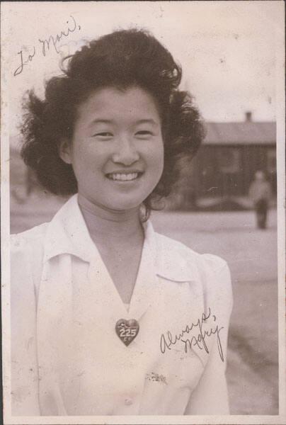 [Portrait of young woman, Mary, with heart shaped pin 225, Heart Mountain, Wyoming, ca. 1942-1945]