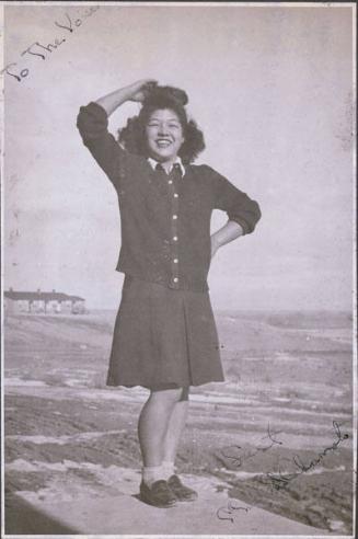 Portrait of May Nakamoto posing in open area, Heart Mountain, Wyoming, 1944]