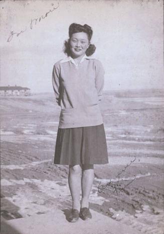 [Young woman standing outdoors, Heart Mountain, Wyoming, 1944]