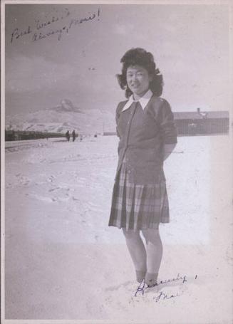 [Portrait of Mae Suzuki standing in snow with Heart Mountain in background, Heart Mountain, Wyoming, Winter 1944-1945]
