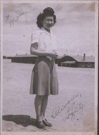 [Portrait of Shizu Y. with barracks in background, Heart Mountain, Wyoming, 1945]
