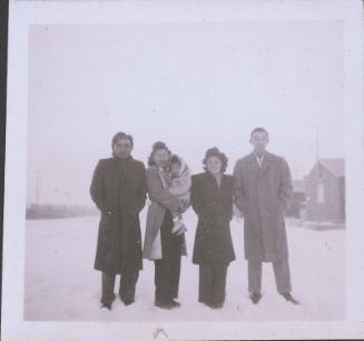 [Two couples and a child standing in snow, Heart Mountain, Wyoming, Winter 1944-1945]