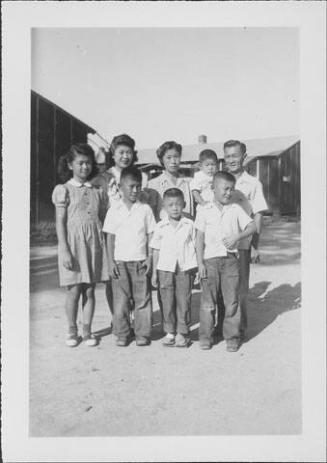 [Group portrait of three adults and five children outside, Rohwer, Arkansas, September 3, 1944]