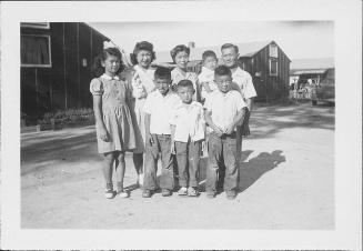 [Three adults and five children outside, portrait, Rohwer, Arkansas, September 3, 1944]