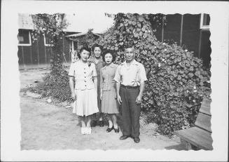 [Three women and a man in front of vines, full-length portrait, Rohwer, Arkansas]