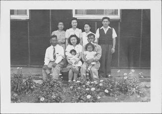 [Famiy of nine and flowerbeds, Rohwer, Arkansas, April 15, 1945]