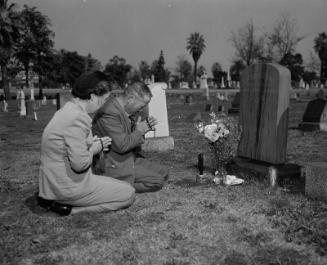 [Mr. and Mrs. Kiyohito Kawakami at Takejiro Kawakami's grave in Evergreen Cemetery, Los Angeles, California, March 21, 1951]