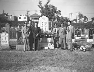 [Kyodo News Service staff next to Komai headstone at cemetery, Los Angeles, California, September 12, 1951]