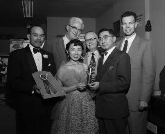 [Mrs. Toki Robinson of Modern Shoe Repair receiving Jake award, California, December 9, 1954]