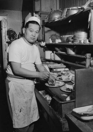 [Cook preparing food at Daruma Cafe, Los Angeles, California, April 5, 1955]