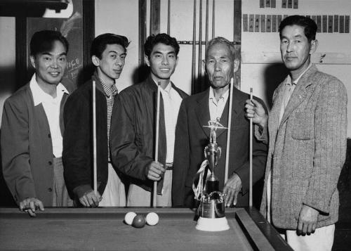 [Frank Kumagai and friends holding pool cues with trophy, California, May 10, 1955]