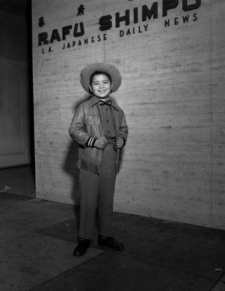 [Little boy movie star, George Matsui, from Shochiku in front of Rafu Shimpo, Los Angeles, January 1956]