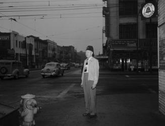 [Shriner William J. Gullett standing on street corner, Los Angeles, California, June 22, 1950]