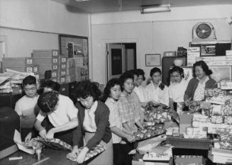 [Youths wrapping gifts for annual JACL Christmas Cheer program, Los Angeles, California, December 17, 1956]