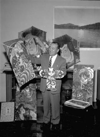 [Shigeru Nakamura, Consul General of Japan, holding Japanese kites, California, March 6, 1957]