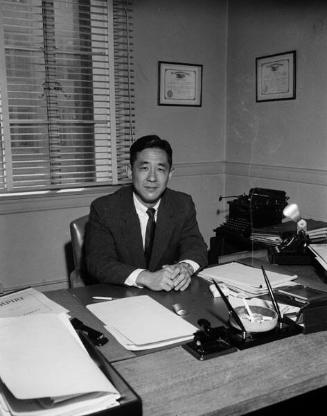 [Mr. Mitsumori sitting at desk, California, June 1957]