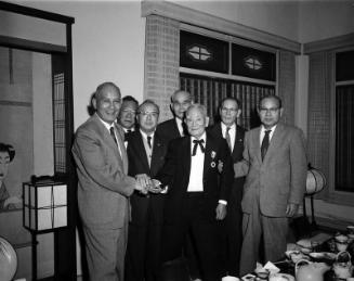 [Mr. Kino and Mr. Fujioka shaking hands at Kawafuku restaurant, Los Angeles, California, November 6, 1957]