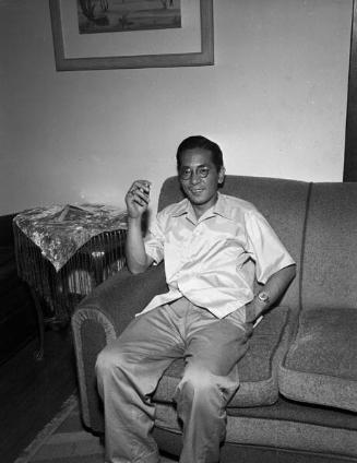 [Mr. Takeuchi, smoking on couch, California, July 21, 1955]